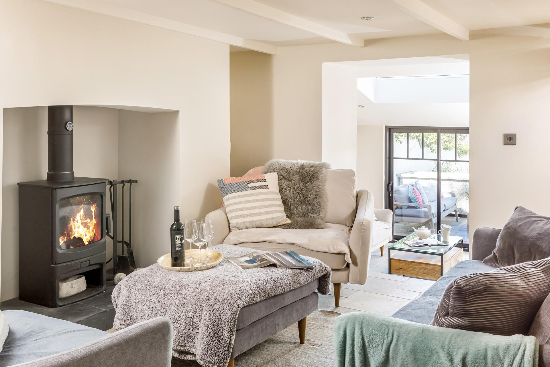 A few steps lead down from the sitting area, into the light and airy sunroom. 