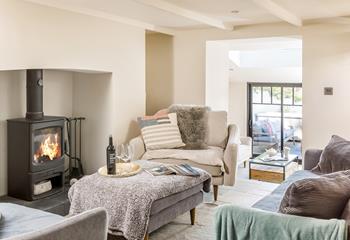 A few steps lead down from the sitting area, into the light and airy sunroom. 