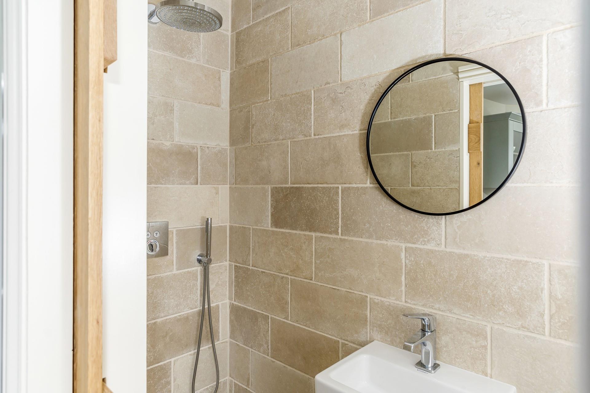 A convenient shower room set just off the kitchen, with a luxurious rainfall shower.