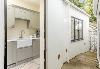 The utility room is at the back of the house, accessed from the kitchen. 