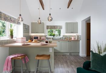 We love the stylish hanging lights and pastel pink appliances!