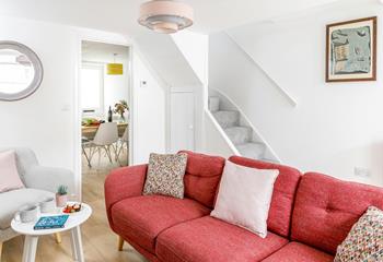 Bright furnishings add a pop of colour to the cosy sitting room.