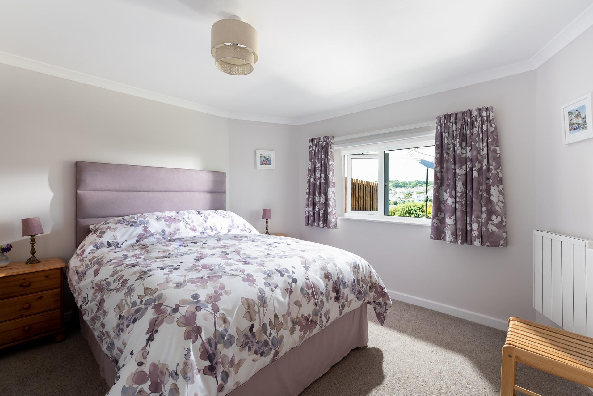 Snuggle up in the spacious king size bed and drift off for a peaceful night's sleep after a busy day.