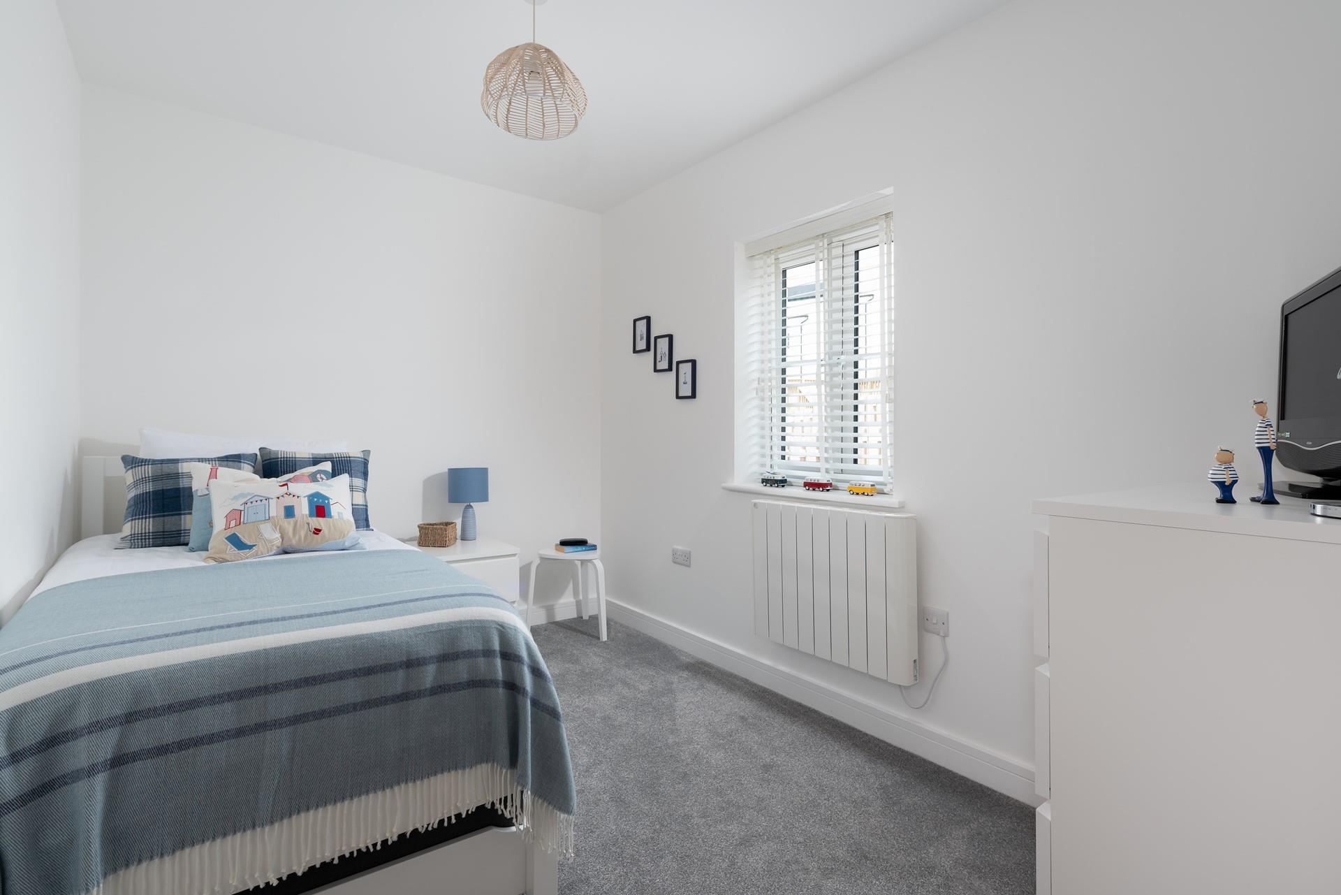 Bedroom 3 has a single bed with a trundle underneath for flexible sleeping arrangements.