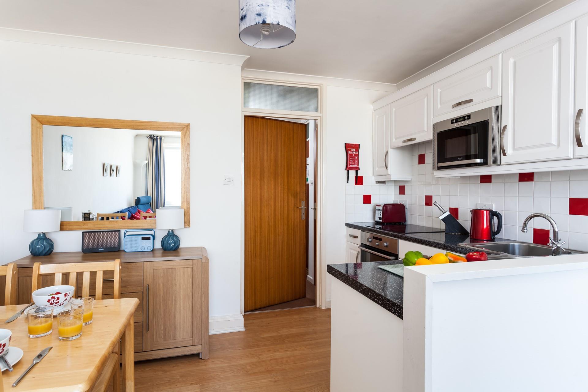 Although compact, the kitchen is fully equipped for cooking tasty meals.