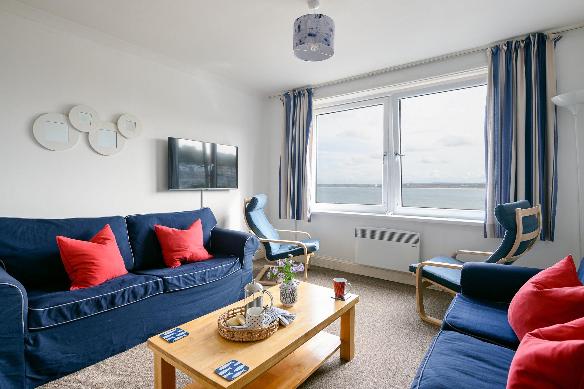 The cosy living room offers stunning views across St Ives Bay.