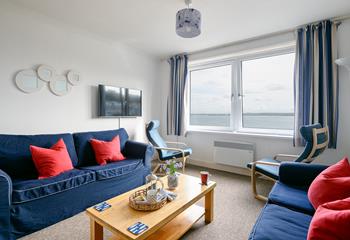 The cosy living room offers stunning views across St Ives Bay.