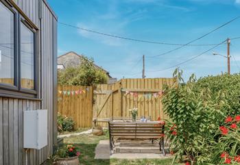 Fencing around the garden which is decorated so lovely with colourful flags.