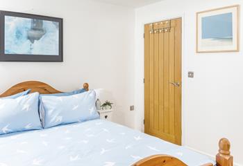 The bedroom is beautifully decorated with a picture of the sea.