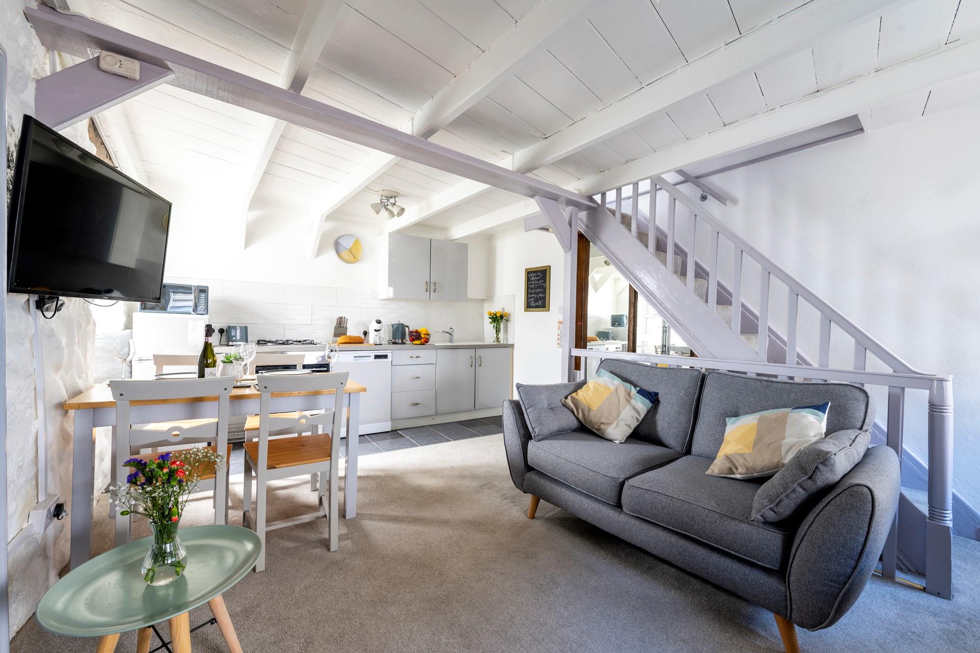 The open plan living area is cosy and light for relaxing and dining.