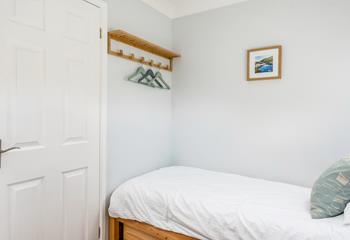 Handy hanging space and handcrafted underbed storage make this a great space for the kids.