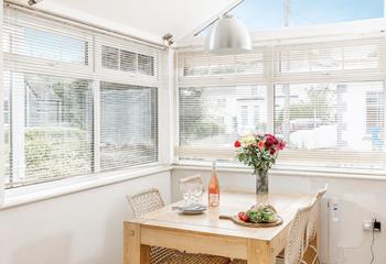 French doors let light flood into the open plan dining and kitchen area.