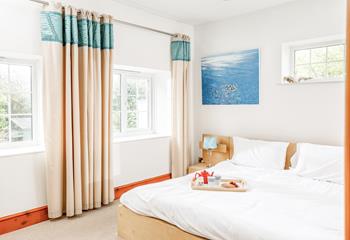 The master bedroom boasts a king size bed and rural views.