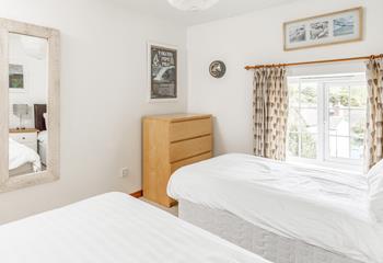 A lovely, light bedroom with storage and rural views.