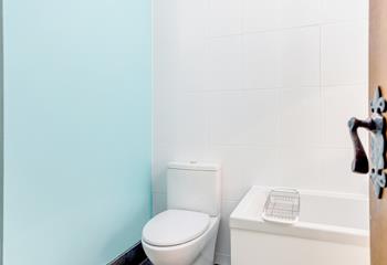 Fresh and light, the bathroom has underfloor heating and a heated towel rail.