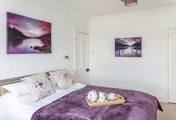 The sumptuous master bedroom, is spacious with calming tones.