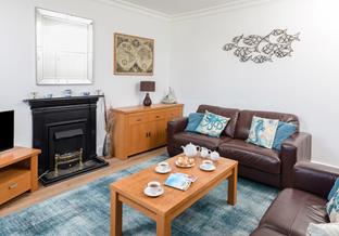Relax with family and friends in the comfortable living room.