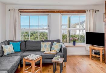 Cosy up in the sitting room with the beautiful sea view backdrop.