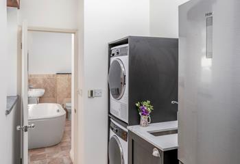 The utility room has a washer, and dryer and leads into the bathroom.