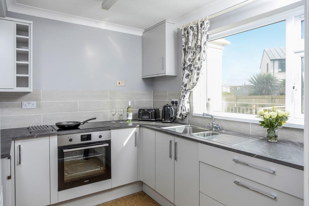 The beautifully light kitchen is great for cooking tasty feasts. Or serving up a local takeaway.