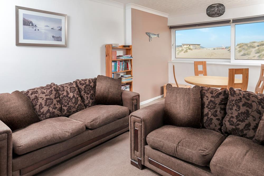 The open plan living area makes the most of the beautiful beach and sea views!