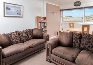 The open plan living area makes the most of the beautiful beach and sea views!