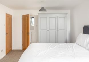 The master bedroom benefits from a connecting nursery space with a cot.