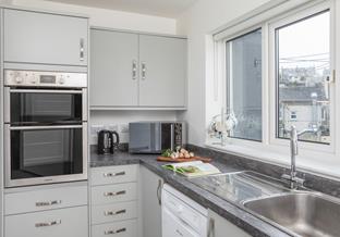 The chic kitchen is well-equipped with all you need to cook with ease.