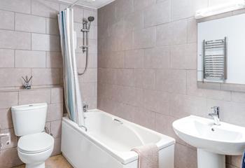 The stylish bathroom boasts a bath and shower, for a long soak or quick rinse.