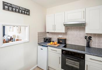 The kitchen has plenty of worktop space to prepare and cook meals.