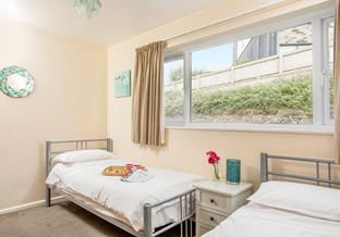 The cosy twin bedroom is a calming sanctuary.