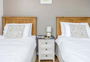 The twin bedroom is a coastal-inspired sanctuary.