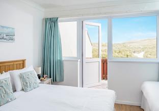 Wake up, open the balcony door wide and let the sounds of the sea float in.