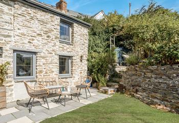 The stone cottage has ample outside space, with several seating areas.
