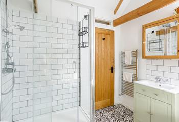 A stylish Victorian-inspired bathroom with rainfall shower, subway tiling and heated towel rail. 