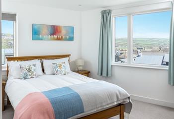 The master bedroom enjoys beautiful views across the village.