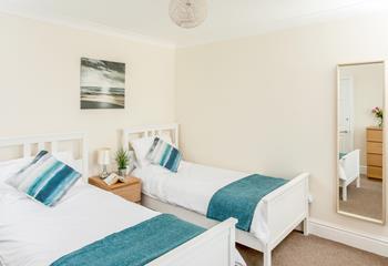 Coastal decor and comfortable twin beds in the second bedroom.