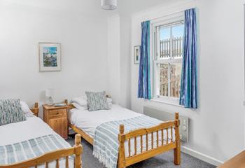 Adults or children will sleep well in the serene twin bedroom.
