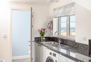 The utility room has a washing machine and tumble dryer.