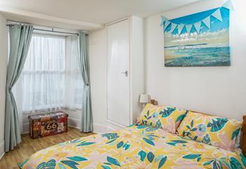 Wake up to a bright and sunny bedroom, and open the windows to the sounds of beach life.