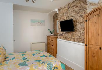 The master bedroom boasts a traditional Cornish stone feature wall.