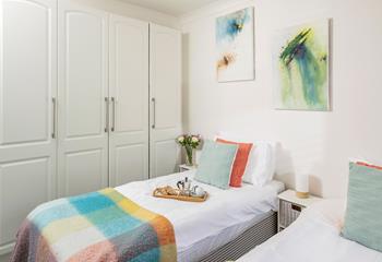 Sink into a dreamy night's sleep in the simple and serene twin bedroom.