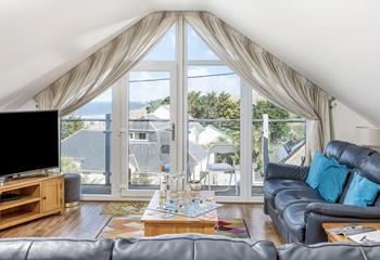 Floor to ceiling windows offer sweeping views across Perranporth and out to sea.