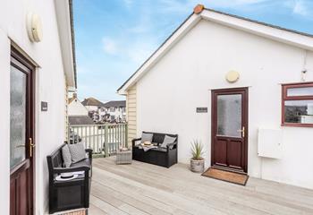 A shared decking area overlooks the high street and beach.