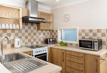 The compact kitchen is fully-equipped with all you need for a relaxing stay.