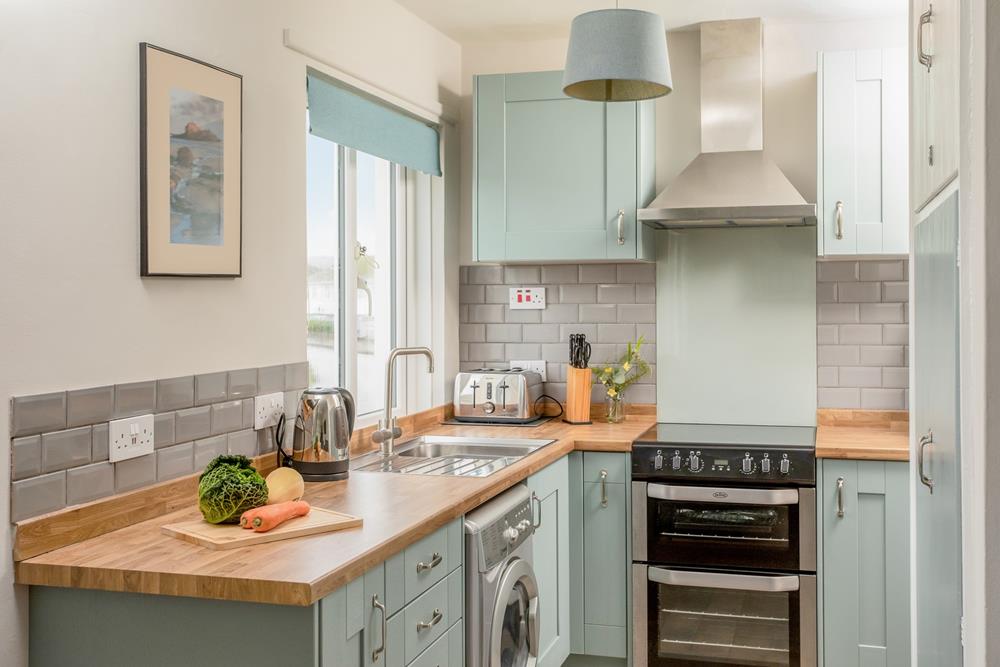 Pastel shades and chic wood make the kitchen a delightful space to cook.
