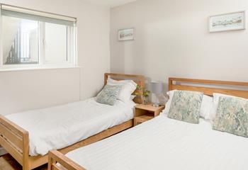 The tranquil family bedroom sleeps three guests.