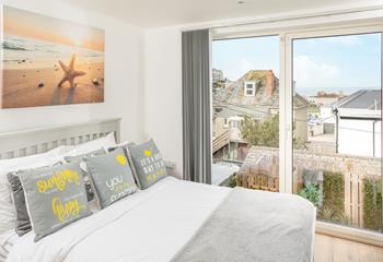 Wake up to views across the beach! The second double bedroom overlooks the high street to Chapel Rock.