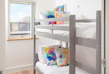 A colourful bunk bedroom for the littler ones, complete with books and toys for the kids to enjoy.