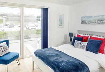 The light and bright master bedroom is full of coastal decor and cosy finishing touches.